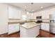 Bright kitchen with white cabinetry, granite countertops, and stainless steel appliances at 6333 Silver Moon Ct, Indianapolis, IN 46259