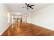 Open living room with wood floors, ceiling fan, and a view into the kitchen at 6333 Silver Moon Ct, Indianapolis, IN 46259