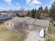 Aerial view of stone-clad exterior with attached garage and well maintained lawn at 6412 Lava Ct, Indianapolis, IN 46237