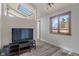 Bedroom featuring a skylight, dark vinyl floors, and a television on a stand at 6412 Lava Ct, Indianapolis, IN 46237