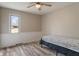 Cozy bedroom featuring wood-look floors and a sunlit window with views to the outside at 6412 Lava Ct, Indianapolis, IN 46237