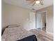 Neutral bedroom with wood-look floors, ceiling fan, and a mirrored closet at 6412 Lava Ct, Indianapolis, IN 46237