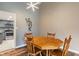 Cozy dining area with a wooden table set, view into the kitchen and modern light fixture at 6412 Lava Ct, Indianapolis, IN 46237