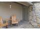 Inviting front porch featuring a cozy seating area with wooden chairs and a decorative wind chime at 6412 Lava Ct, Indianapolis, IN 46237
