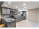 Modern kitchen featuring gray cabinetry, stainless steel appliances, tile backsplash, and stone countertop peninsula at 6412 Lava Ct, Indianapolis, IN 46237