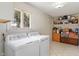 Convenient laundry room with shelving, a window, and tile floor at 6412 Lava Ct, Indianapolis, IN 46237