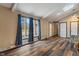 Bright living room featuring a stone fireplace, hardwood floors, and large windows with blue curtains at 6412 Lava Ct, Indianapolis, IN 46237