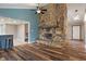 Spacious living room featuring a stone fireplace and wood floors at 6412 Lava Ct, Indianapolis, IN 46237