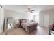 Well-lit bedroom with a large bed, ceiling fan, and a full length mirror at 6481 W Treeline Ln, McCordsville, IN 46055