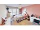 Bright bedroom featuring a pink accent wall, white furniture and window at 6481 W Treeline Ln, McCordsville, IN 46055