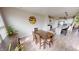 Cozy dining area boasts hardwood floors, an inviting table setting, and a seamless transition to the modern kitchen at 6481 W Treeline Ln, McCordsville, IN 46055