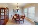Dining room with a wood table, china cabinet, and a large window with natural light at 6481 W Treeline Ln, McCordsville, IN 46055