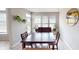 Inviting dining room with a large table set by window, hardwood floors, and a view of the backyard at 6481 W Treeline Ln, McCordsville, IN 46055