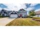 Beautiful two-story home with well-manicured lawn, navy and gray siding, and a red front door at 6481 W Treeline Ln, McCordsville, IN 46055