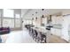 Bright, open kitchen with a large island, white cabinets, and stainless steel appliances at 6481 W Treeline Ln, McCordsville, IN 46055