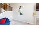 Living room with fireplace, modern art, and staircase at 6481 W Treeline Ln, McCordsville, IN 46055
