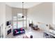 Open-concept living room, dining area, and kitchen with soaring ceilings and large windows at 6481 W Treeline Ln, McCordsville, IN 46055