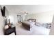 Spacious main bedroom features a sliding door, ceiling fan and king bed at 6481 W Treeline Ln, McCordsville, IN 46055