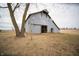Rustic barn with a weathered exterior and an open doorway in a grassy field at 695 N 650 W, Lebanon, IN 46052