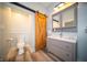Bathroom with modern vanity, wood-look flooring, and barn door to the main bedroom at 695 N 650 W, Lebanon, IN 46052