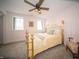 Charming bedroom featuring a gold metal bed frame and a ceiling fan with decorative lighting at 695 N 650 W, Lebanon, IN 46052