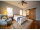Bright bedroom with hardwood floors, a ceiling fan, and natural light at 695 N 650 W, Lebanon, IN 46052