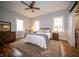 Cozy bedroom featuring windows, hardwood floors, and a ceiling fan at 695 N 650 W, Lebanon, IN 46052