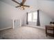 Carpeted bonus room featuring natural light from large windows and built-in storage at 695 N 650 W, Lebanon, IN 46052