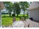 Outdoor deck with seating overlooking a lush green lawn, surrounded by mature trees and picturesque scenery at 695 N 650 W, Lebanon, IN 46052