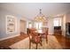 Traditional dining room featuring a wooden table, patterned rug, and elegant chandelier at 695 N 650 W, Lebanon, IN 46052