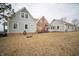 Back of house featuring light-colored siding, brick accents, and multiple windows for ample natural light at 695 N 650 W, Lebanon, IN 46052