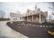 Charming home featuring a full front porch and landscaped garden beds, with a walkway to the house at 695 N 650 W, Lebanon, IN 46052
