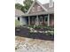 Charming home featuring a brick facade, inviting front porch, and meticulously landscaped flowerbeds at 695 N 650 W, Lebanon, IN 46052