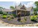 Beautiful front yard with mulched flower beds and vibrant plants leading up to a charming home with a welcoming porch at 695 N 650 W, Lebanon, IN 46052