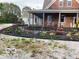 Charming home featuring a brick facade, inviting front porch, and meticulously landscaped flowerbeds at 695 N 650 W, Lebanon, IN 46052