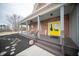 Spacious front porch perfect for relaxing, featuring seating and a bright yellow front door at 695 N 650 W, Lebanon, IN 46052