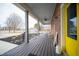 Inviting front porch with ample seating, featuring a ceiling fan and view of landscaped front yard at 695 N 650 W, Lebanon, IN 46052