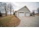 Two-car garage featuring light-colored siding, white doors, and a gravel driveway at 695 N 650 W, Lebanon, IN 46052