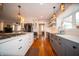 Open-concept kitchen with island cooktop, stainless appliances, and hardwood floors into the dining area at 695 N 650 W, Lebanon, IN 46052