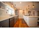 Bright kitchen with a stainless steel farmhouse sink, modern appliances, and open shelving at 695 N 650 W, Lebanon, IN 46052