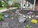 Professionally landscaped flowerbed with river rock walkway, mulch, and colorful flora along the side porch at 695 N 650 W, Lebanon, IN 46052