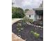 Professionally landscaped flowerbed with river rock walkway, mulch, and colorful flora along the side porch at 695 N 650 W, Lebanon, IN 46052