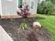 Professionally landscaped flowerbed with mulch and colorful flora along the side of the home at 695 N 650 W, Lebanon, IN 46052