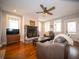Cozy living room featuring a stone fireplace, hardwood floors, and plenty of natural light at 695 N 650 W, Lebanon, IN 46052