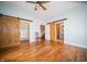 Spacious bedroom with wood floors, barn doors leading to closet and bathroom; stairs visible at 695 N 650 W, Lebanon, IN 46052
