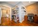 Home office featuring a brick accent wall, built-in shelving, and adjacent kitchen view at 695 N 650 W, Lebanon, IN 46052