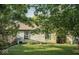 Lush backyard with a well-manicured lawn, mature trees, and partial view of the home's exterior at 7013 Ringtail Ct, Indianapolis, IN 46254