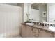 Functional bathroom featuring a double sink vanity, decorative mirror, and shower with a patterned curtain at 7013 Ringtail Ct, Indianapolis, IN 46254