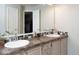 Well-lit bathroom with a double sink vanity, decorative mirror, and modern fixtures at 7013 Ringtail Ct, Indianapolis, IN 46254