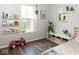 Sunlit bedroom with hardwood floors, a large window, and built-in bookshelves filled with books at 7013 Ringtail Ct, Indianapolis, IN 46254